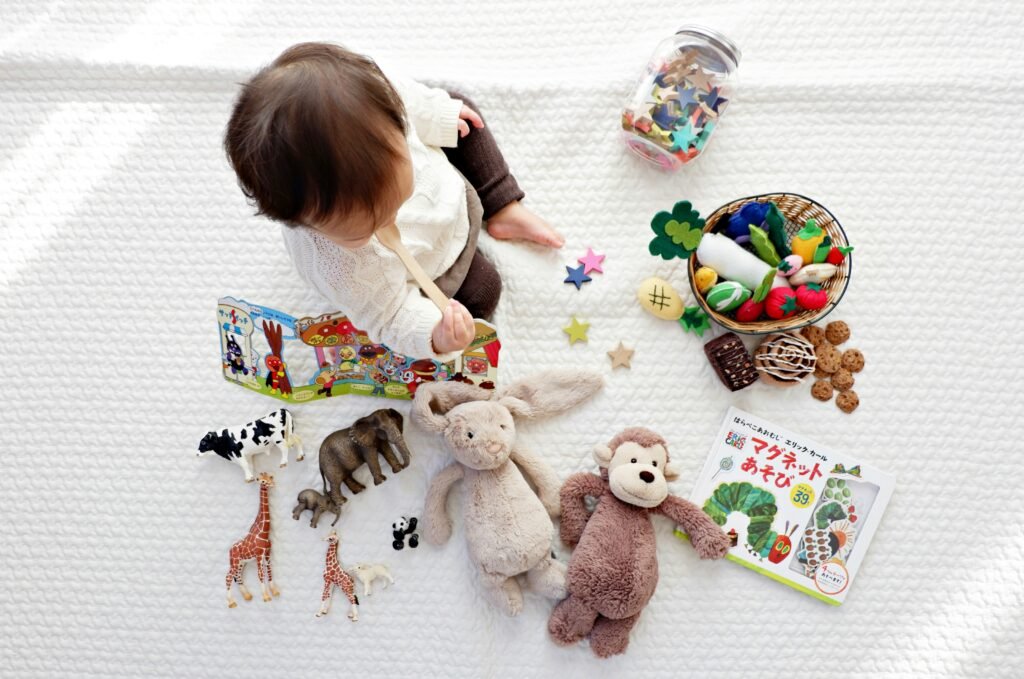 A seated boy defining his favorite plush toys